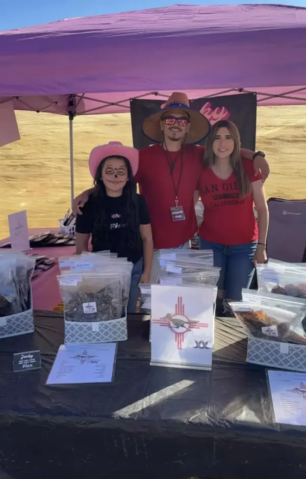 The Jerky Fixx crew behind the booth table