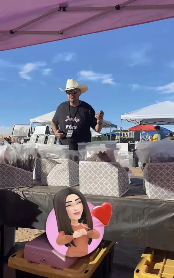 The Jerky Fixx dealer in a cowboy hat behind the booth