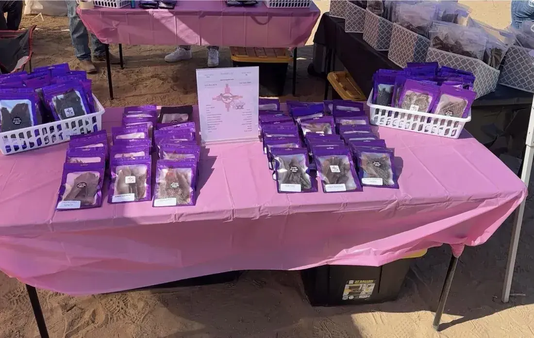 Rows of Jerky Fixx jerky bags on a pink table