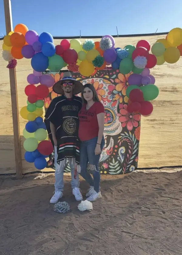 Jerky Fixx couple dressed up at a balloon wall