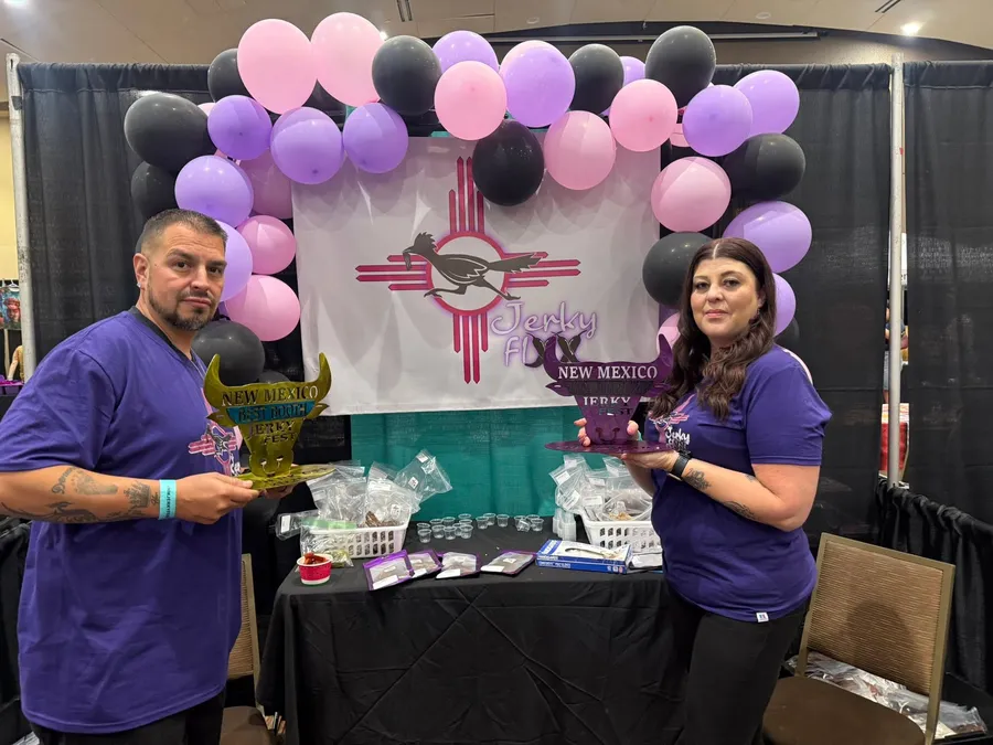 Jerky Fixx owners with their New Mexico Jerky Fest trophies at an indoor booth